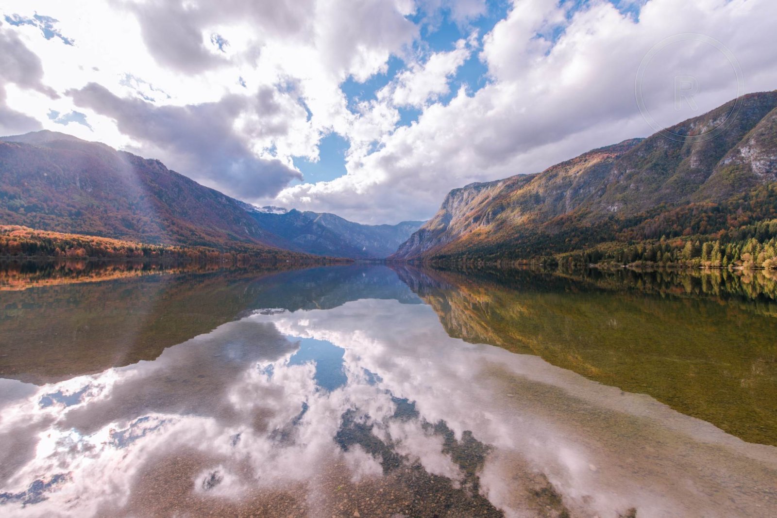 After: the lake and mountain landscape with the circular logo removed