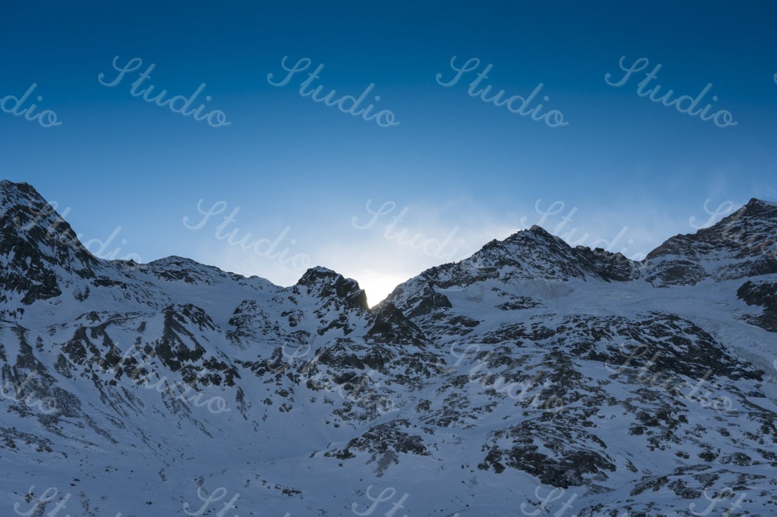 Before: Script text tiled across a snow-covered mountain scene